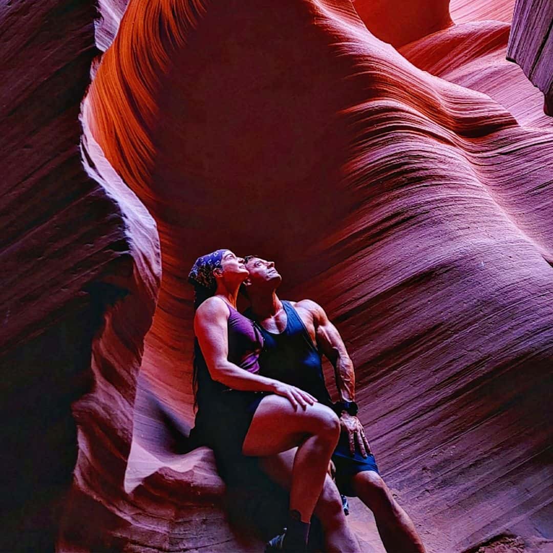 Woman relaxing in Antelope Canyon during sunset, exploring slot canyon beauty.